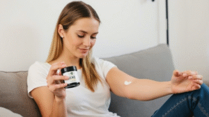 A girl applying Charlotte’s Web Cream on her muscles.
